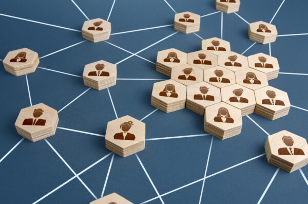 Business Membership product image A group of wooden people connected to each other on a blue background.
