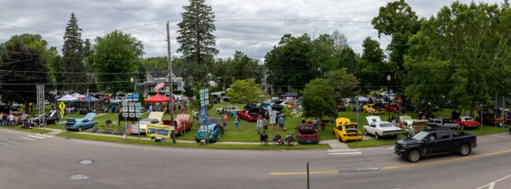 wide shot of swanton park with cars and tents during car show